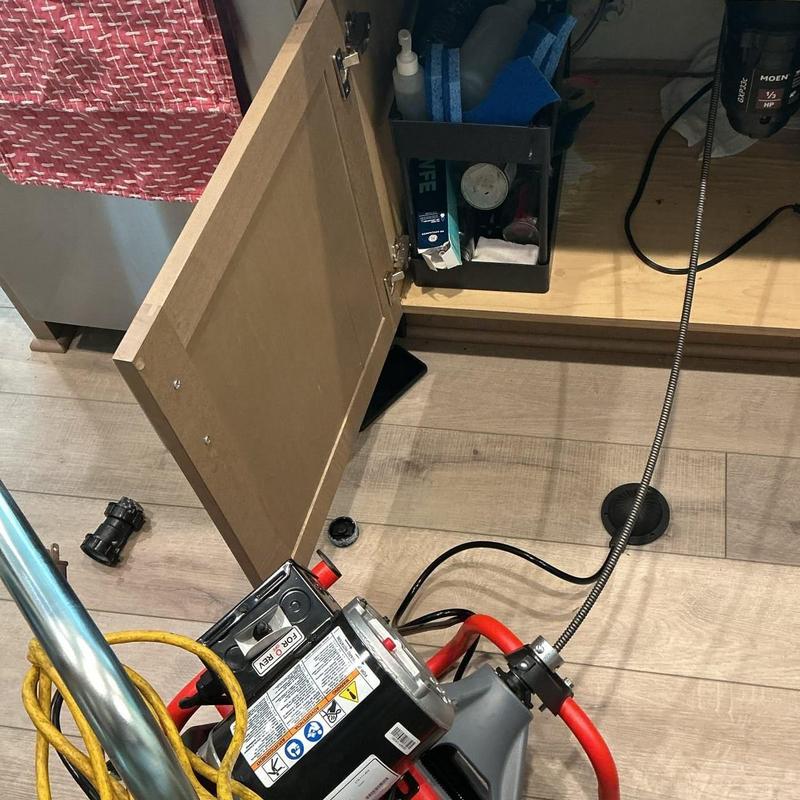 Main drain line cleaning with drain snake equipment