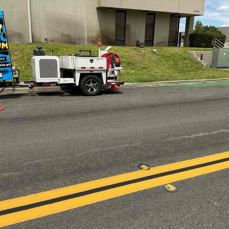 Underground sewer mainline hydro jetting setup on street