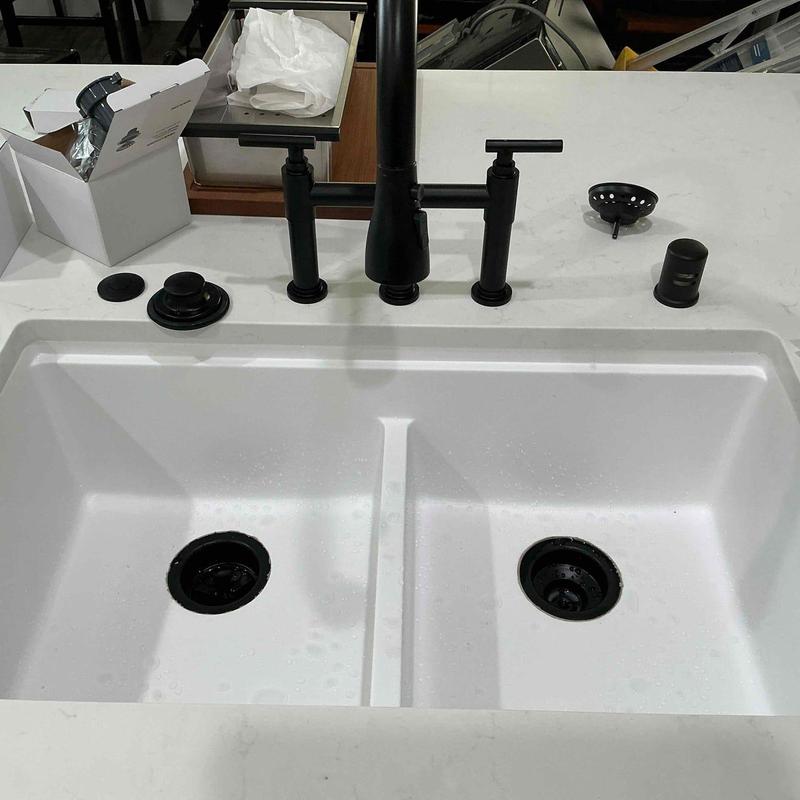 Kitchen sink with black faucets and drain parts