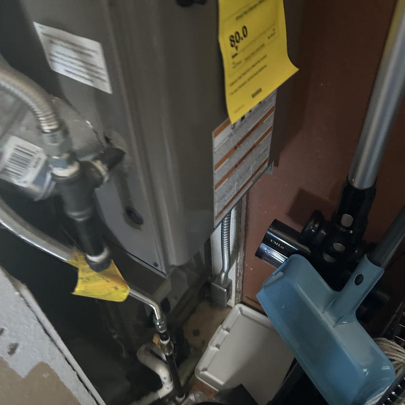 Gas furnace piping and connections with dustpan nearby