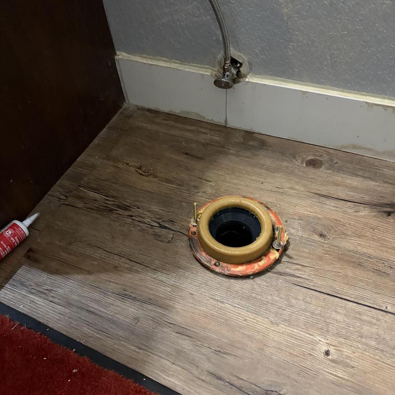 Toilet flange installation on wooden floor with shutoff valve