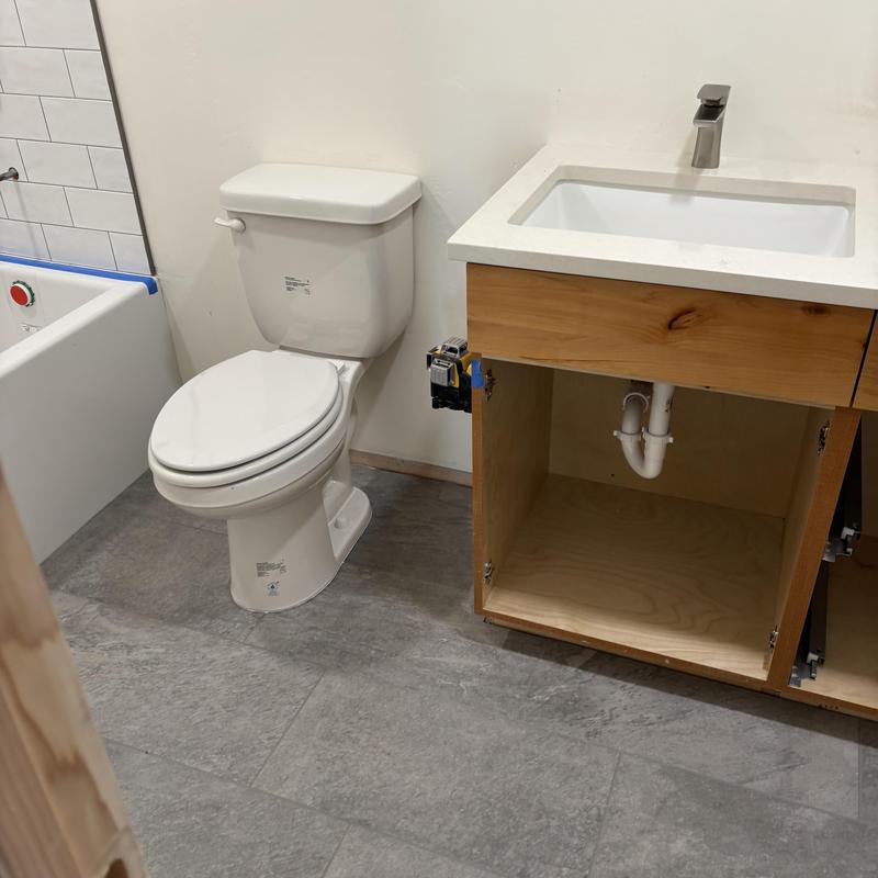 Toilet and sink fixture installation in new bathroom