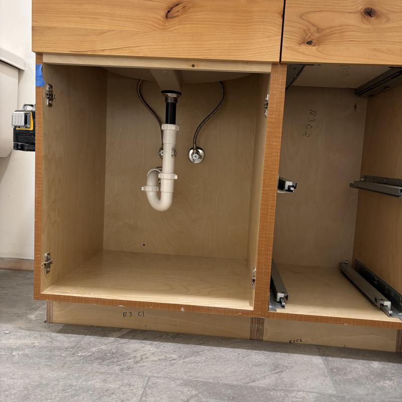 Sink drain and water supply lines under cabinet installation