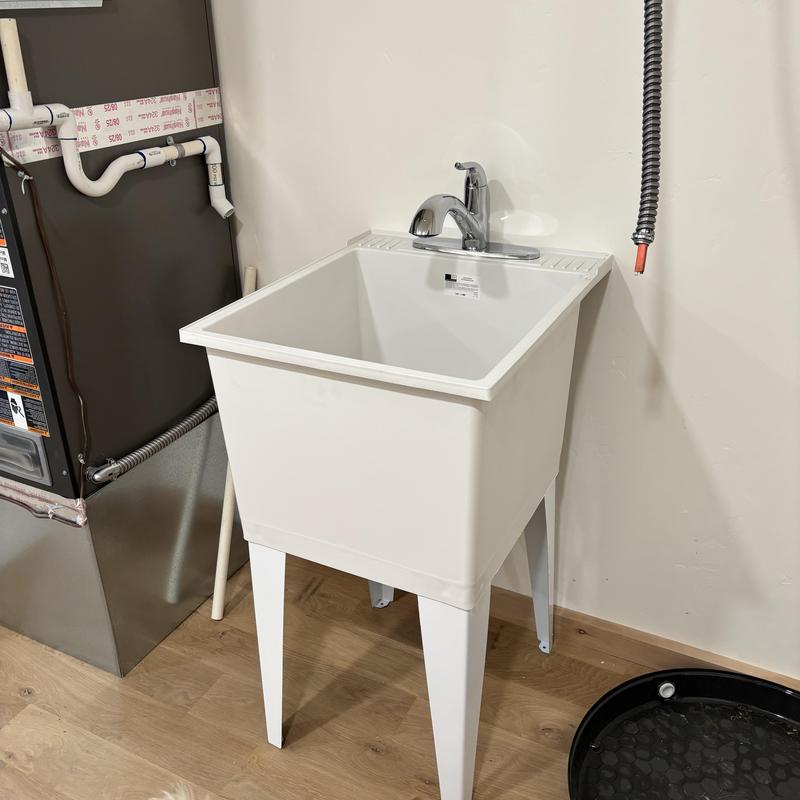 Utility sink with faucet installation in laundry room