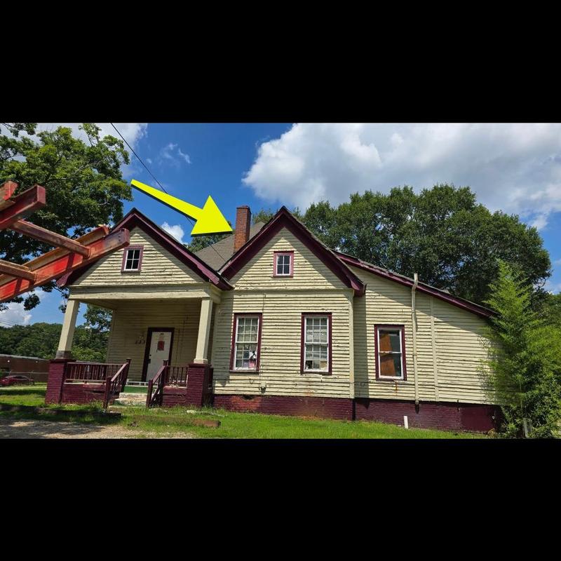 Roof shingles and chimney on old house exterior Roof shingles and chimney on old house exterior