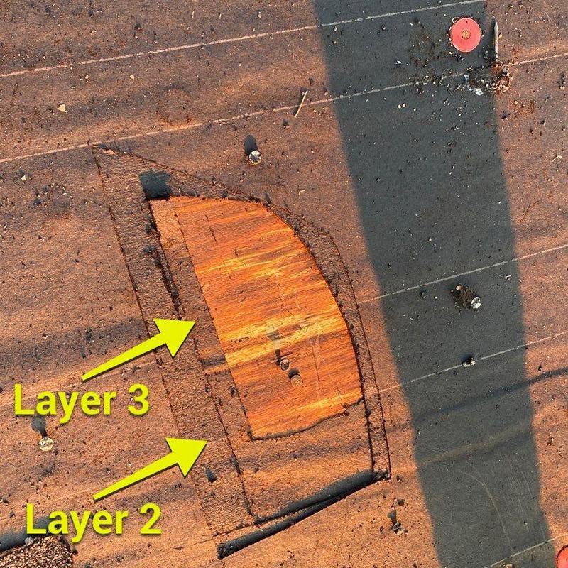 Roof decking exposed under multiple felt layers
