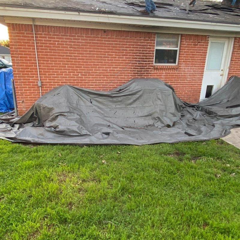 Roof tarp covering removed shingles and decking repair area