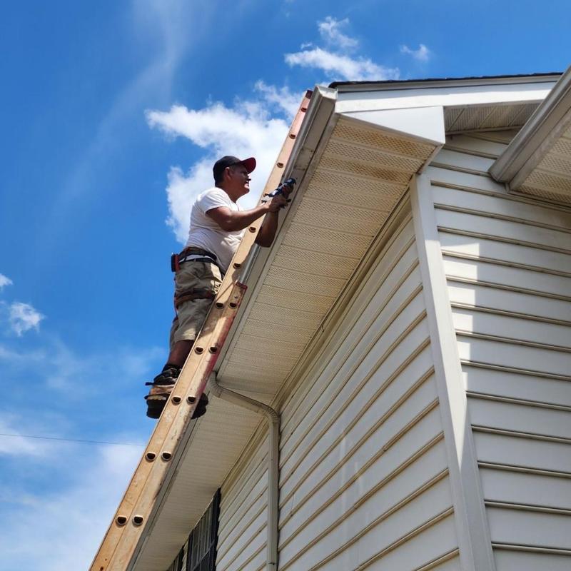 Gutter installation on residential roof edge Gutter installation on residential roof edge