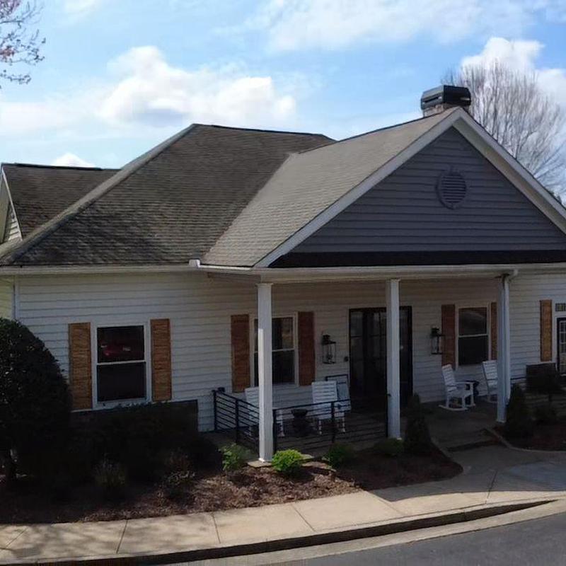 Clubhouse shingle roof with partial sunlight and shadows