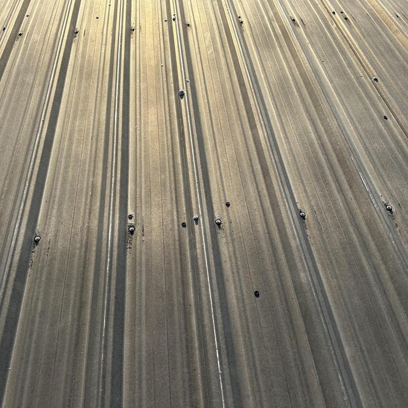 Galvanized metal roofing with replaced fasteners