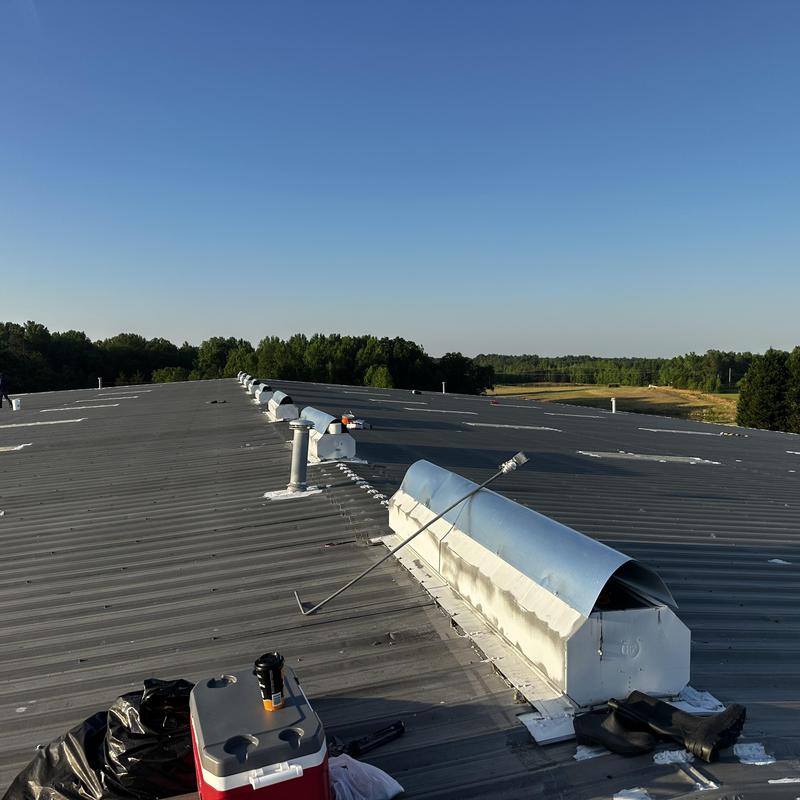 Galvanized ridge vent hood installation on metal roof