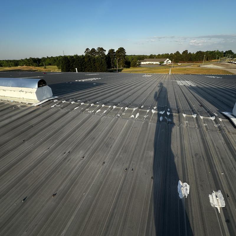 Galvanized ridge vent hood installation on metal roof