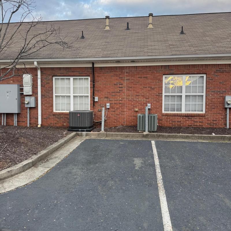 Commercial HVAC units outside brick office building