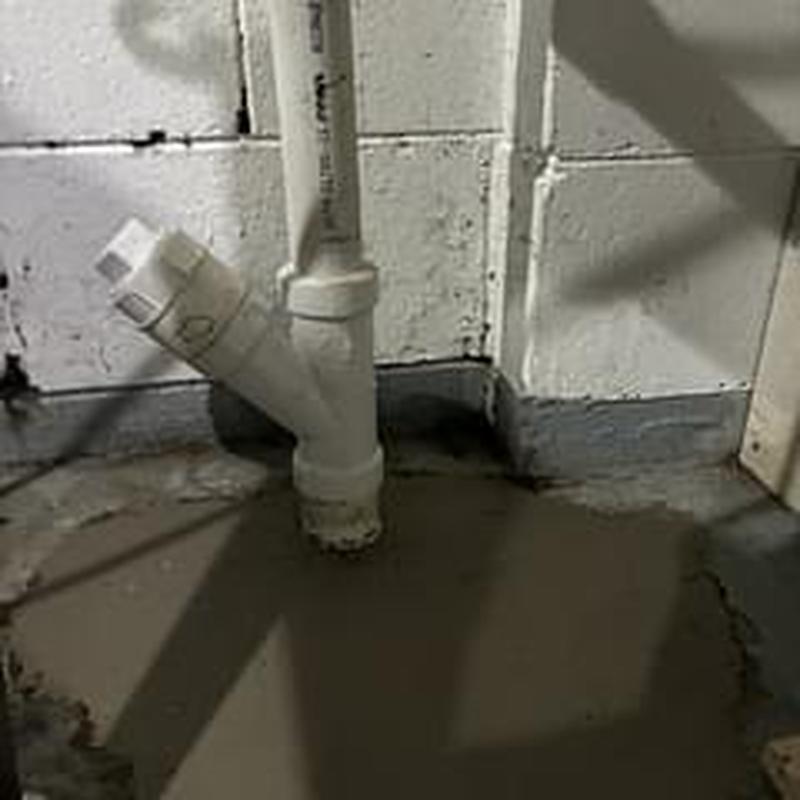 PVC drain pipe and concrete slab patch in basement