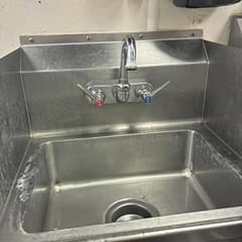 T&S faucet with hot and cold stems on stainless sink