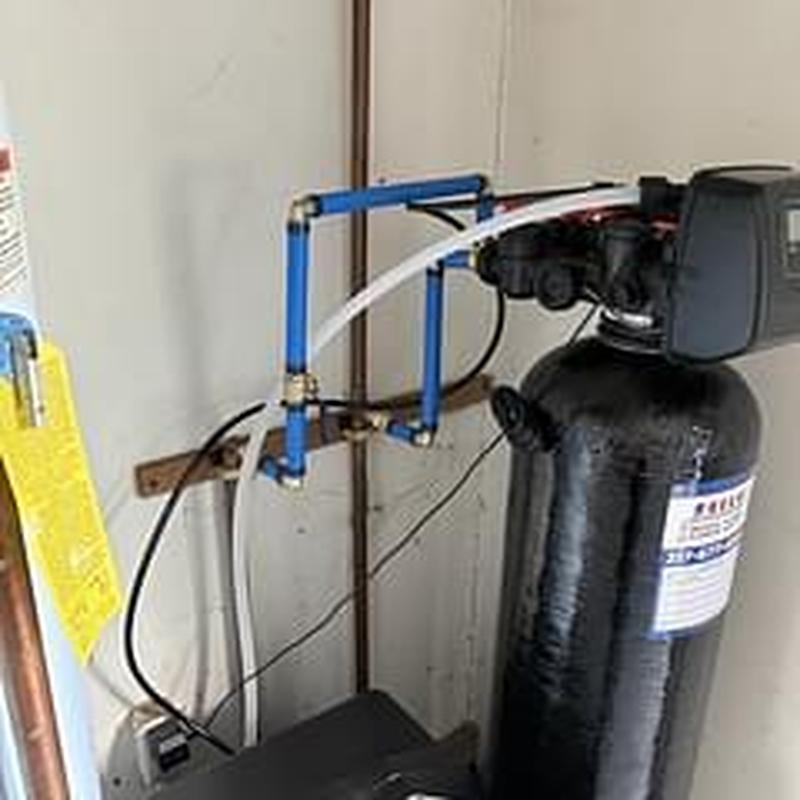 Water softener unit with blue PEX piping installation
