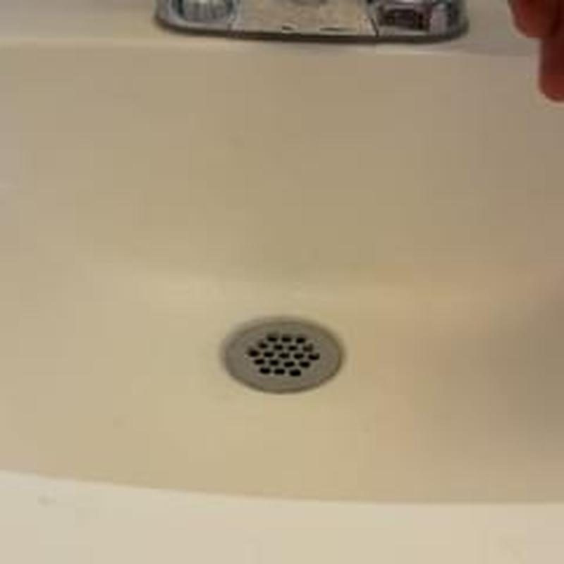 Bathroom sink drain with metal strainer close-up