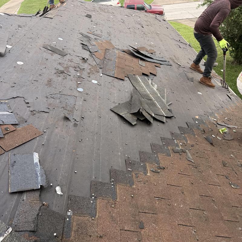 Residential roof tear-off with removed shingles Residential roof tear-off with removed shingles