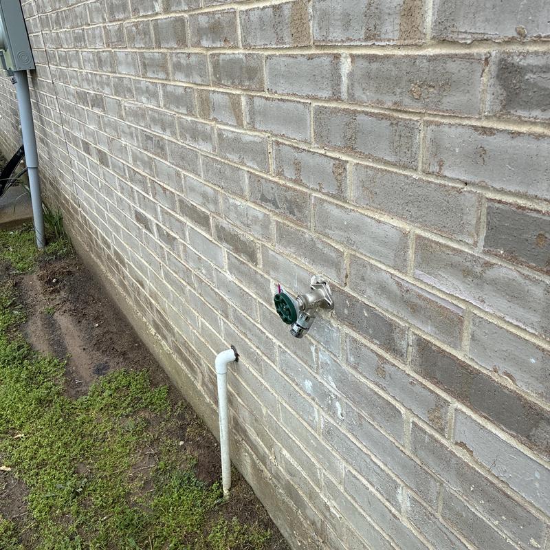 Frost-proof hose bib on exterior brick wall