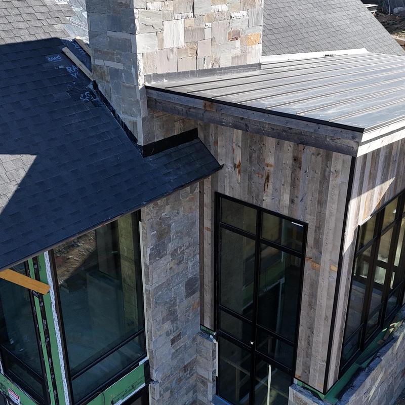Standing seam metal roof and asphalt shingle installation