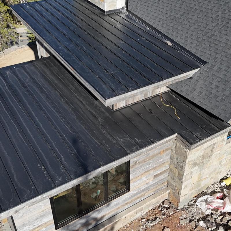 Standing seam metal roof installation on new home