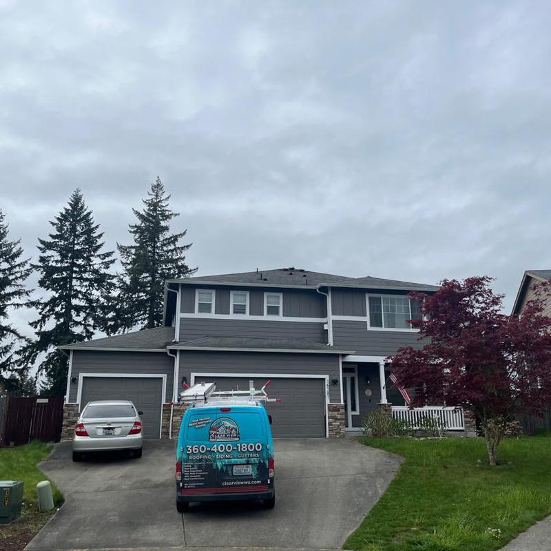Asphalt shingle roof with cleaning service van