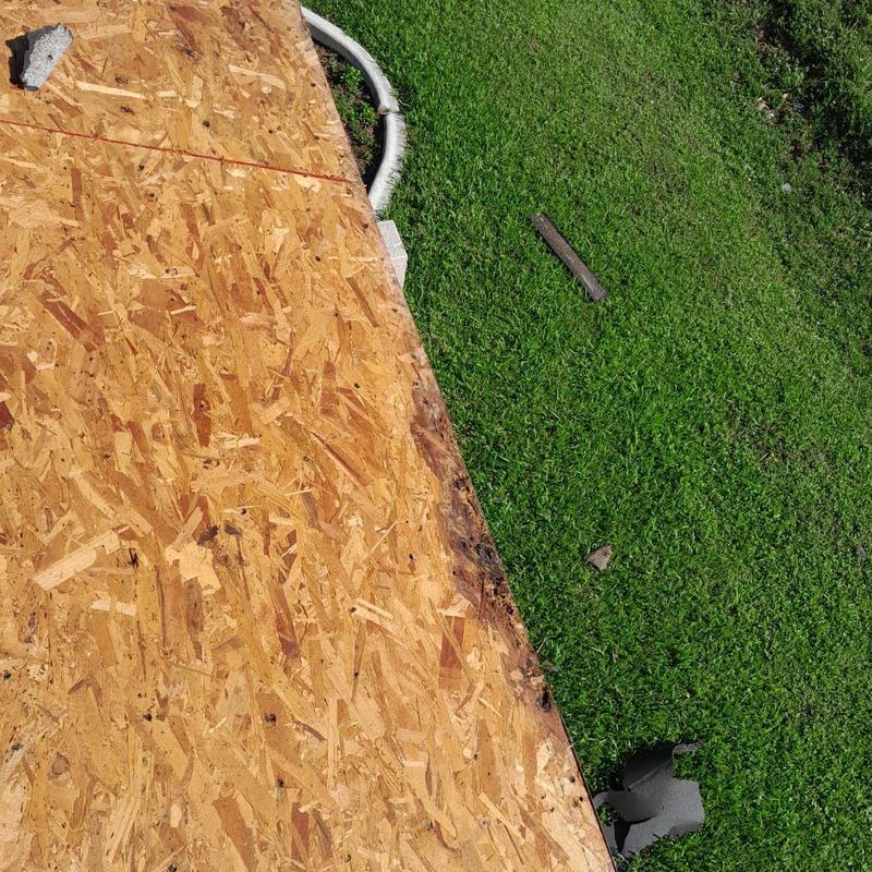 OSB roof decking with damage along edge outdoors