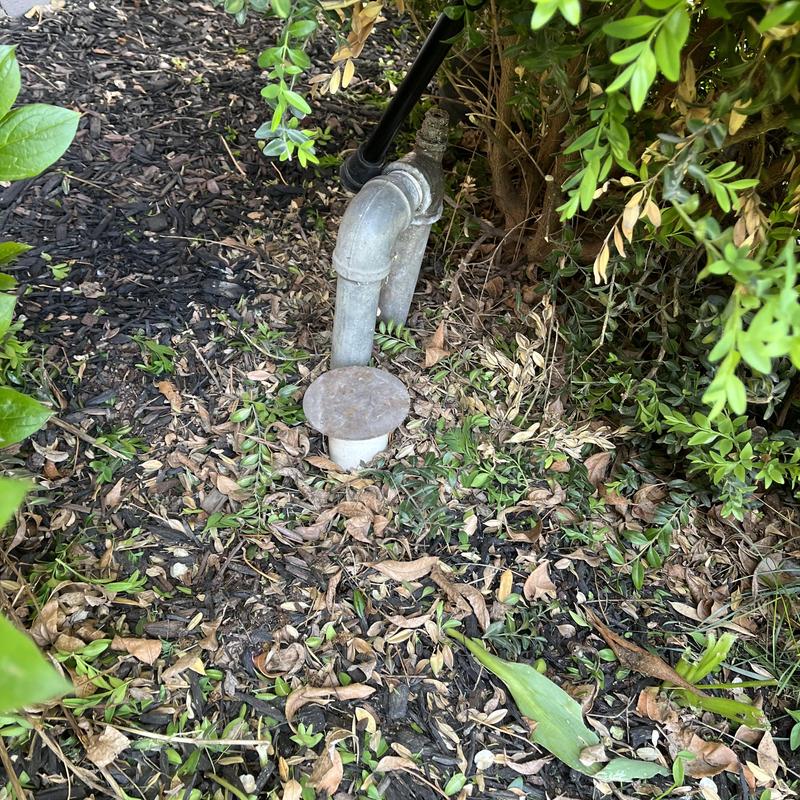 Sprinkler system pipe and valve in garden area