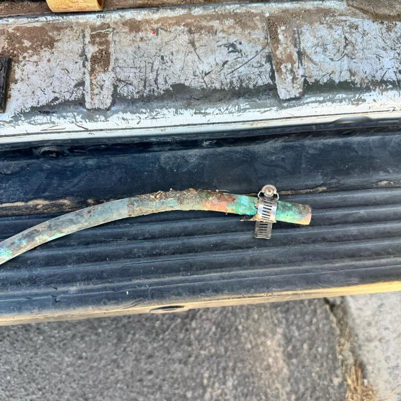 12 copper pipe leak with rusted clamp on truck bed