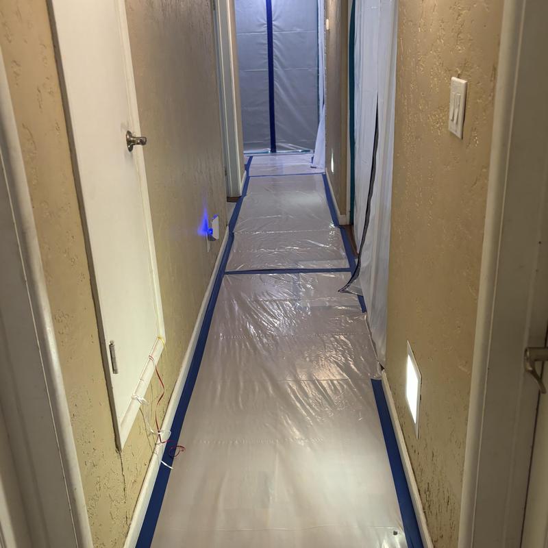 Containment setup with plastic floor and wall barriers Containment setup with plastic floor and wall barriers