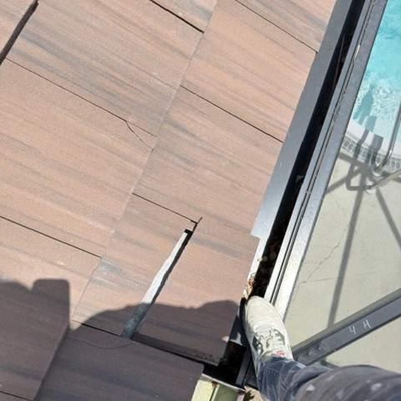 Concrete tile roof with visible cracks near pool area