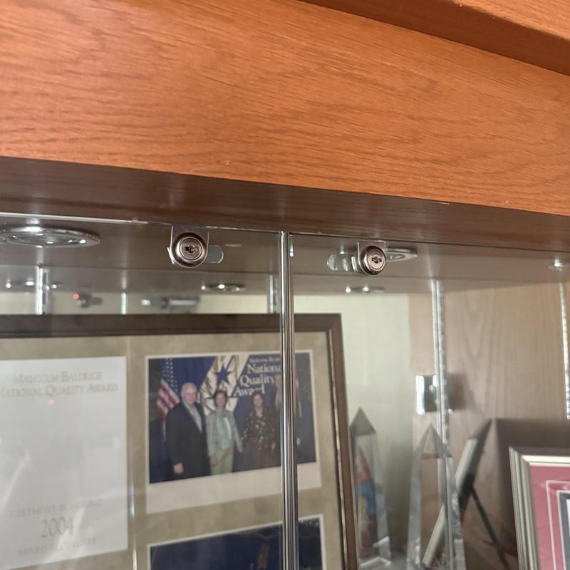 Glass display case locks on wood frame cabinet