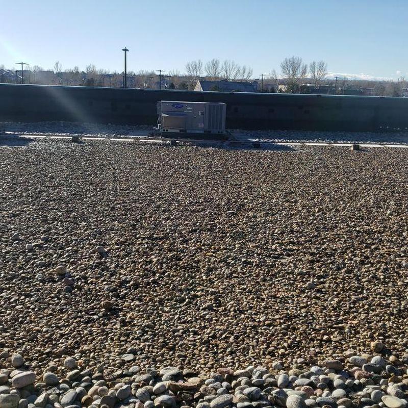 EPDM ballast flat roof with HVAC unit in background