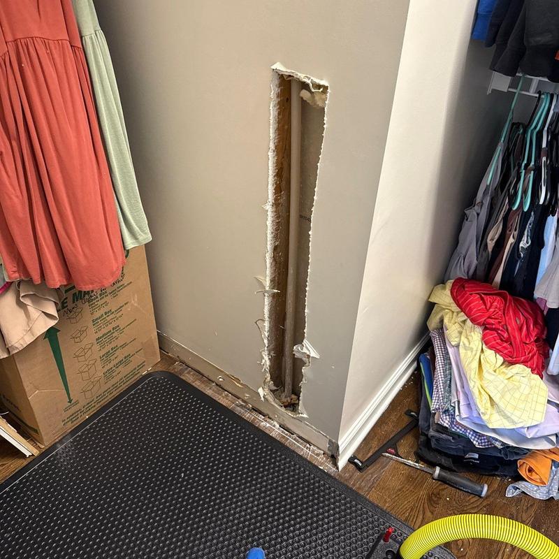 Drywall wall cavity with exposed plumbing pipe