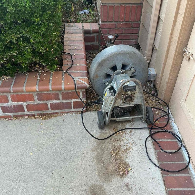 Main sewer line snaking machine near clean-out access