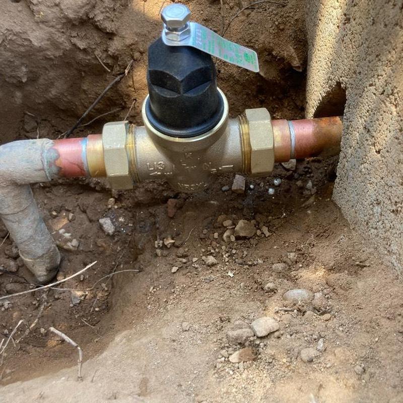 Pressure reducing valve installed in-ground by curb stop