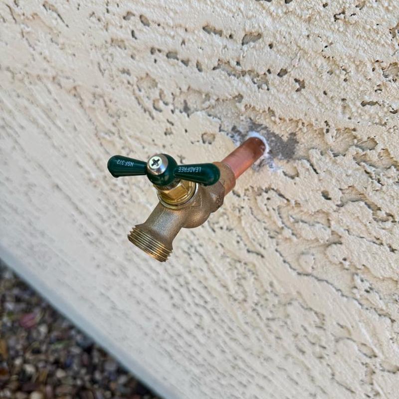 Hose bib installed through stucco wall with copper pipe