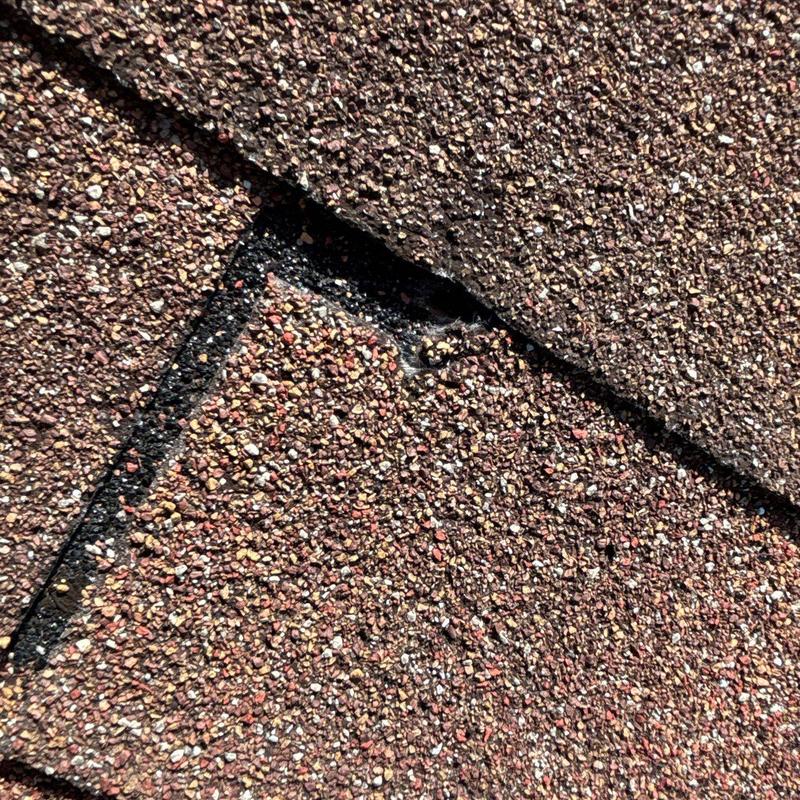 Asphalt shingles with hail damage and worn edges