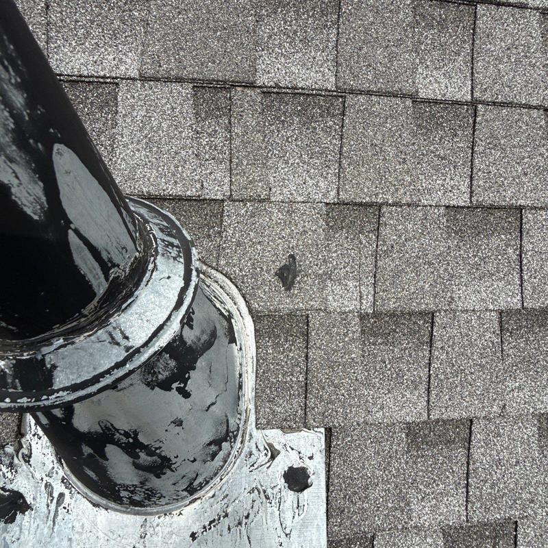 Asphalt shingles with pipe flashing on roof