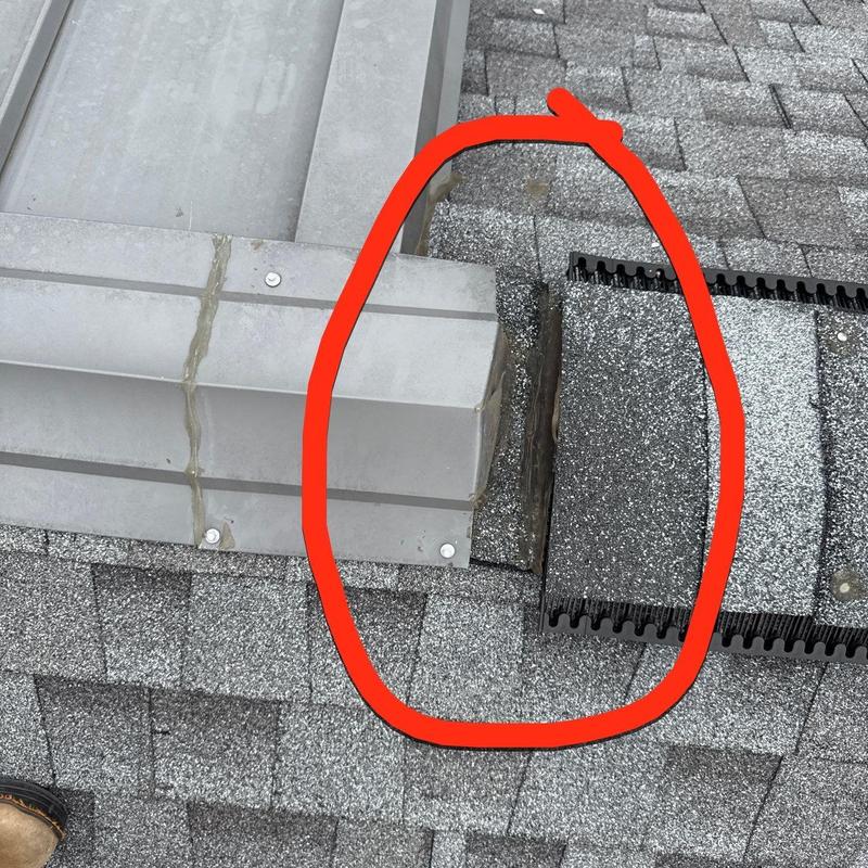 Shingle roof with metal flashing joint damage circled