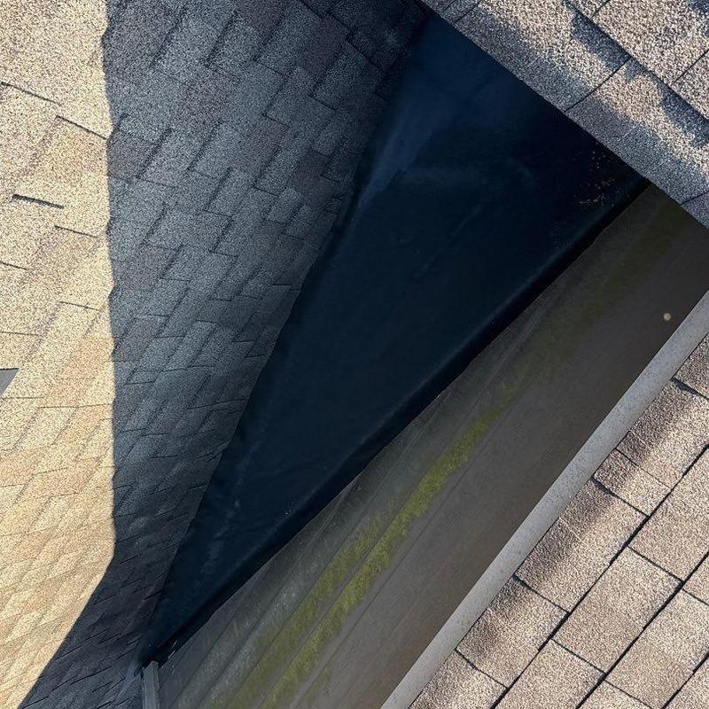 Roof valley with asphalt shingles and underlayment damage