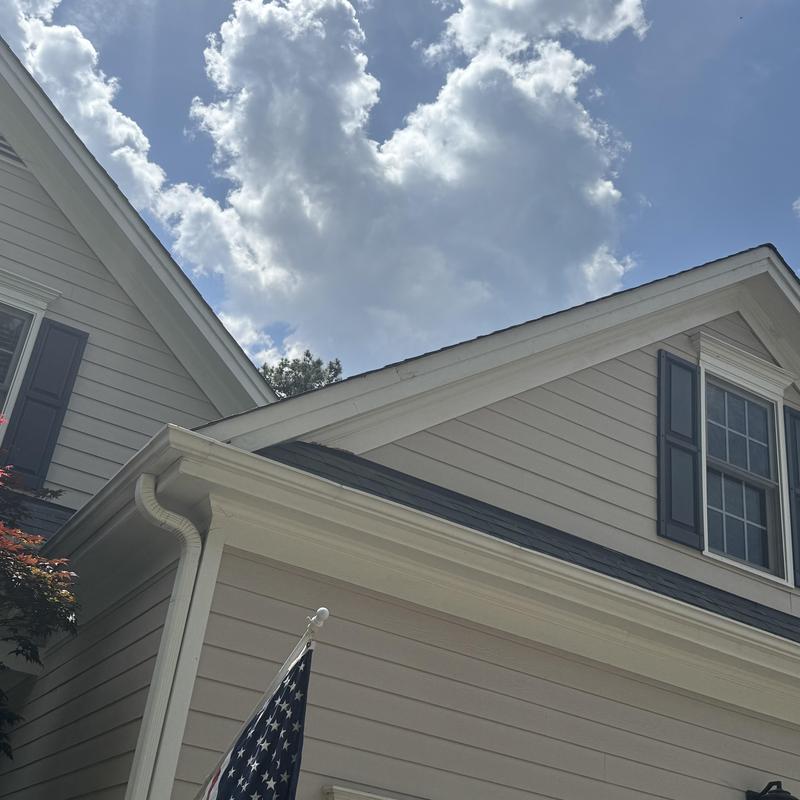 Exterior trim and gutter installation on house facade Exterior trim and gutter installation on house facade