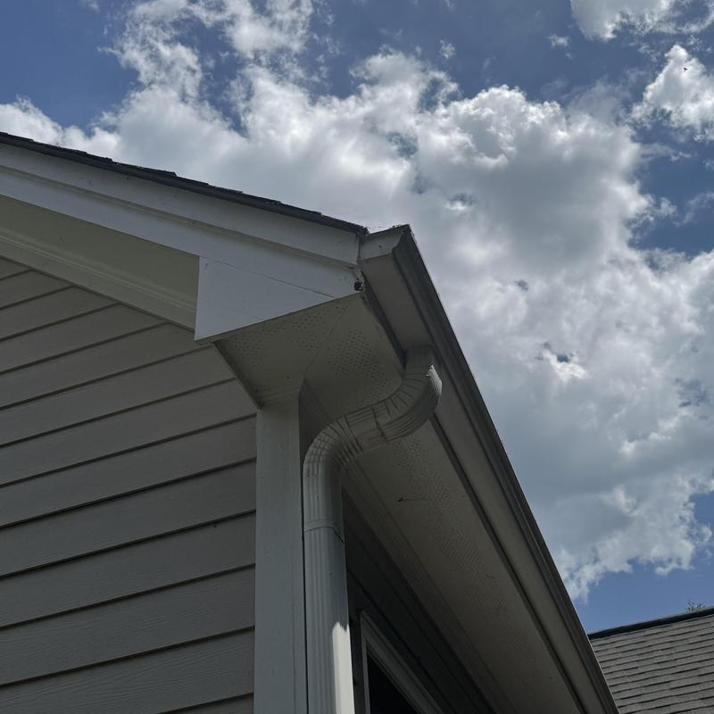 Gutter downspout and exterior trim on house corner Gutter downspout and exterior trim on house corner