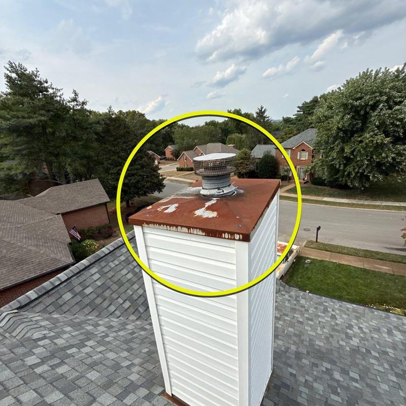 Chimney cap with rust and paint peeling