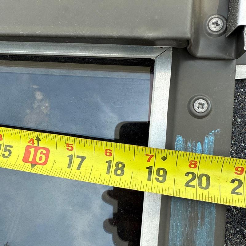 Roof skylight frame with measuring tape across