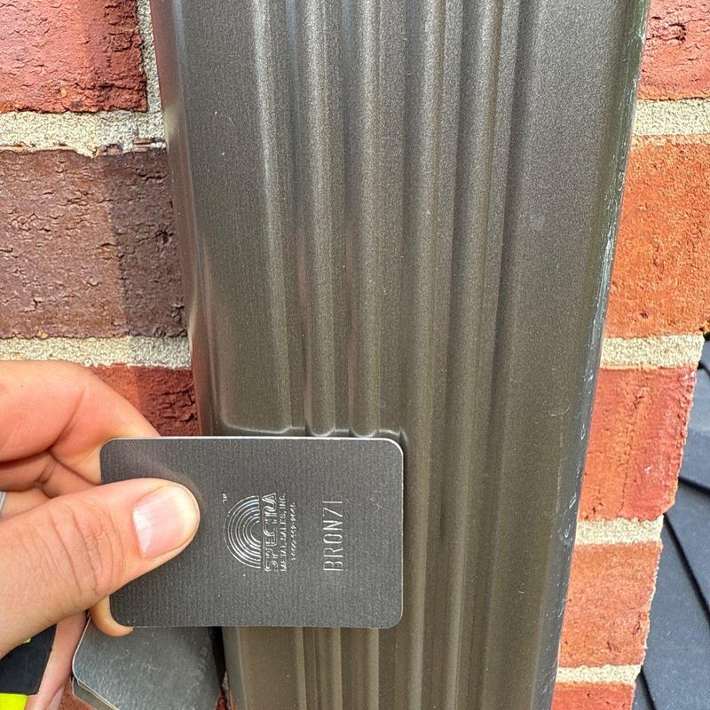Metal gutter color sample comparison against existing gutter