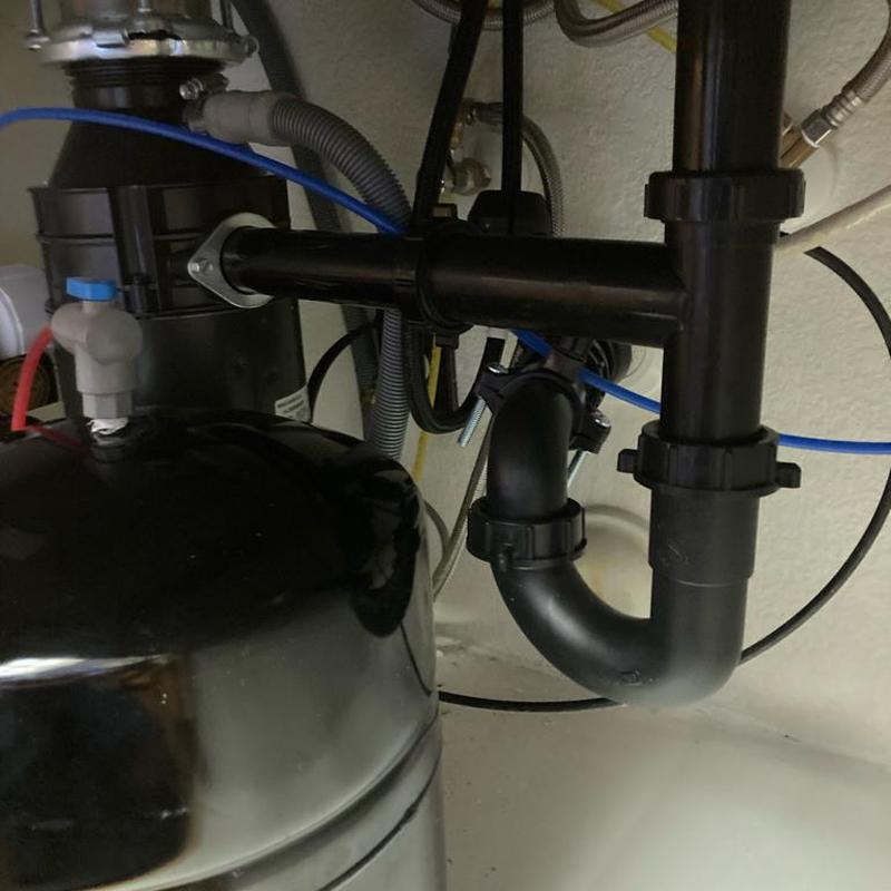 Kitchen sink drain tubing and disposal installation under sink