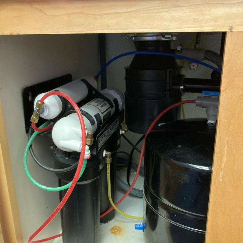 Water filtration system installation with tubing under sink