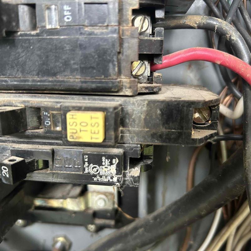Bathroom electrical breaker panel close-up with wires