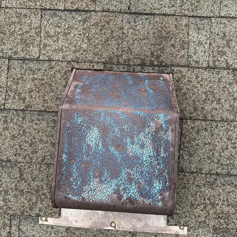 Metal roof vent with rust and corrosion damage